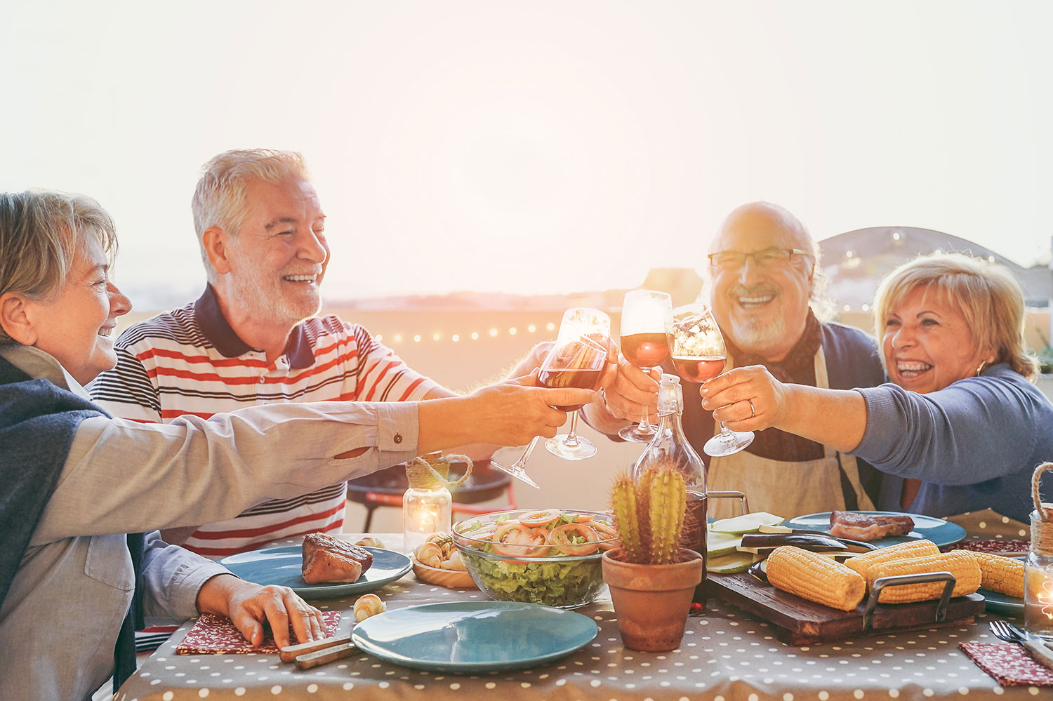 Older-Couples-Cheers A family enjoying their dental implants along with a large meal.
